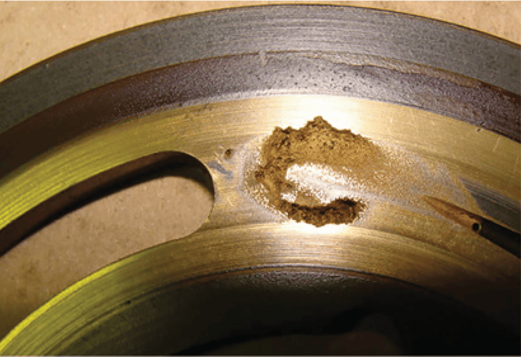 Example of physical cavitation damage due to air contamination in hydraulic system.